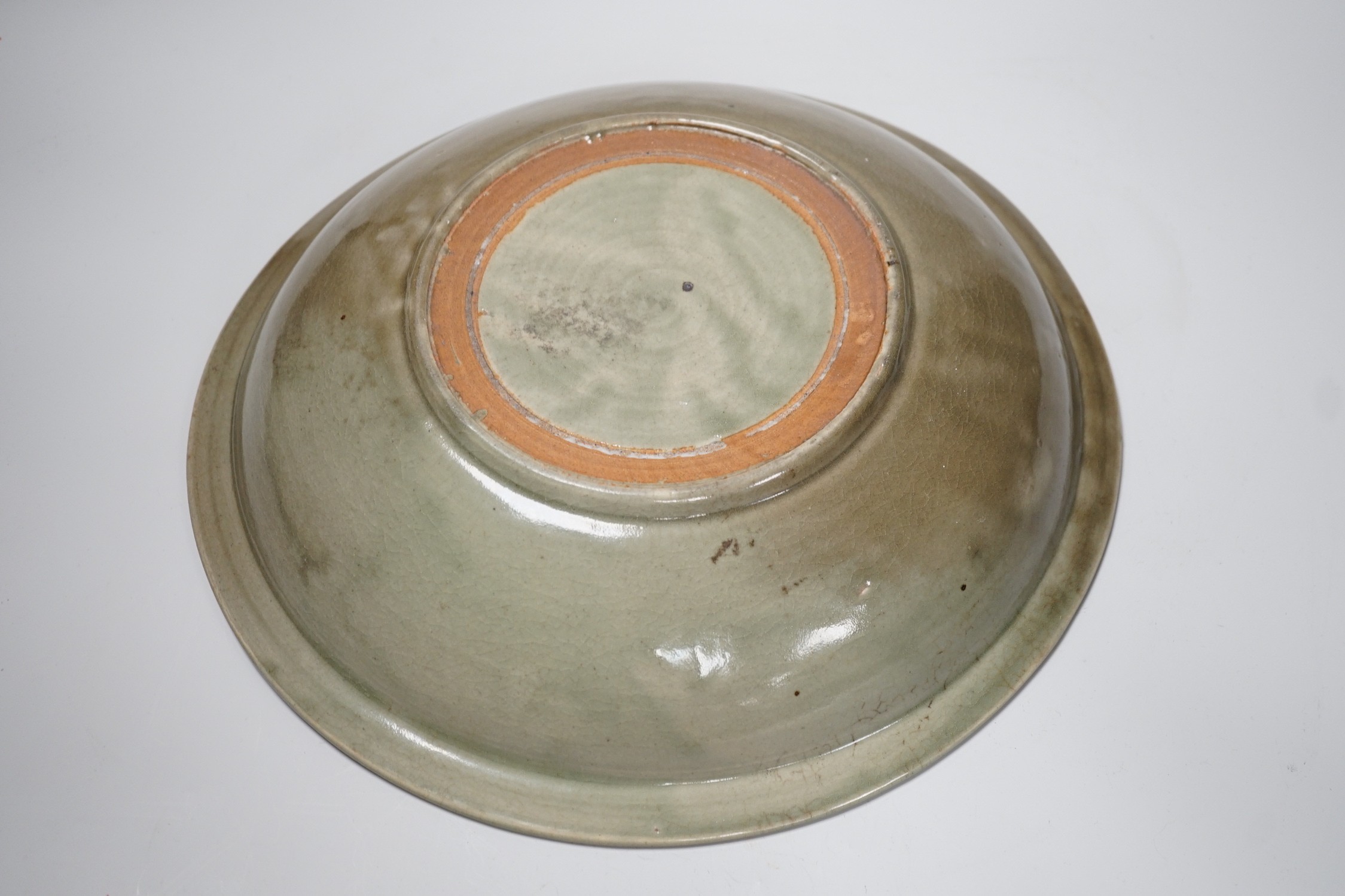 A Chinese Celadon charger. 34cm diameter